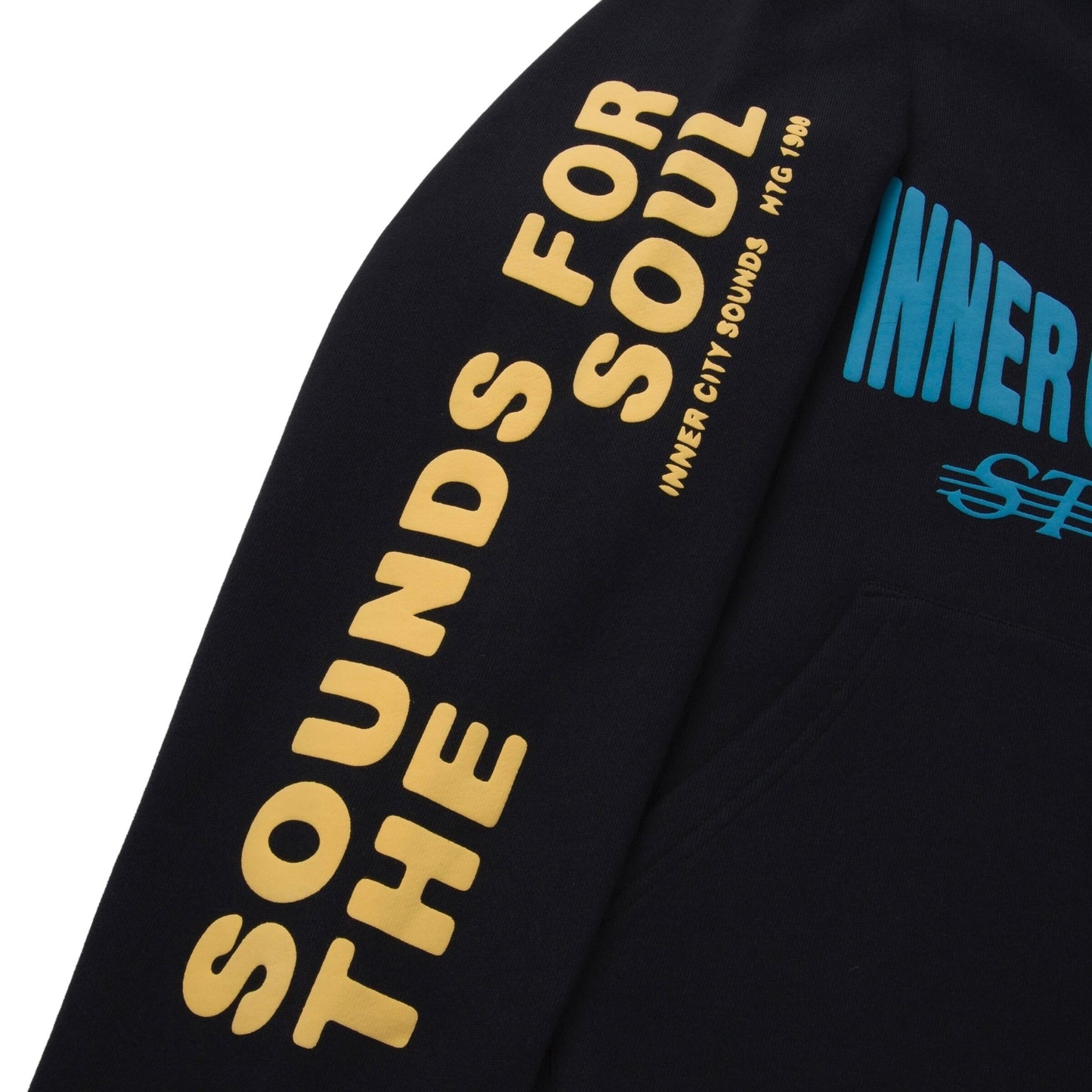 Close-up of an Honor The Gift Studio Hoodie in black, featuring blue and yellow puff print text on the sleeve: "Sounds for the Soul.