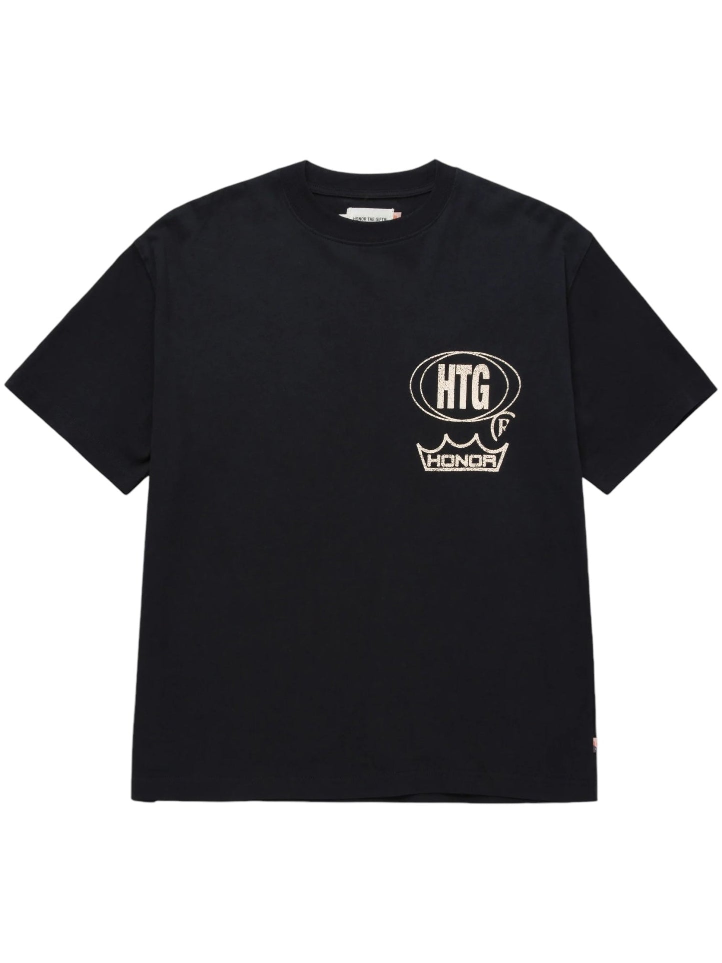 The HONOR THE GIFT STUDIO TEE BLACK, by HONOR THE GIFT, is a black t-shirt made from heavyweight cotton jersey and features a white embroidered patch on the front displaying the letters "HTG," a speech bubble, and the word "HONOR.