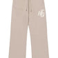 The Honor The Gift Terry HTG Sweatpant Stone by HONOR THE GIFT is made from 100% cotton in beige, featuring a drawstring waist, two front pockets, and the "HTG" initials on the left thigh.