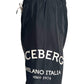 The Iceberg ICE25MBM01 Medium Boardshort in black features a white drawstring, premium polyester fabric, and bold "ICEBERG MILANO ITALIA since 1974" print on the left leg. Brand: ICEBERG.