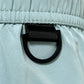 Close-up of a black D-ring on the ICEBERG ICE25MBM01 Medium Boardshort in mint, featuring imported 100% polyester, detailed stitching, and gathered elastic at the top.