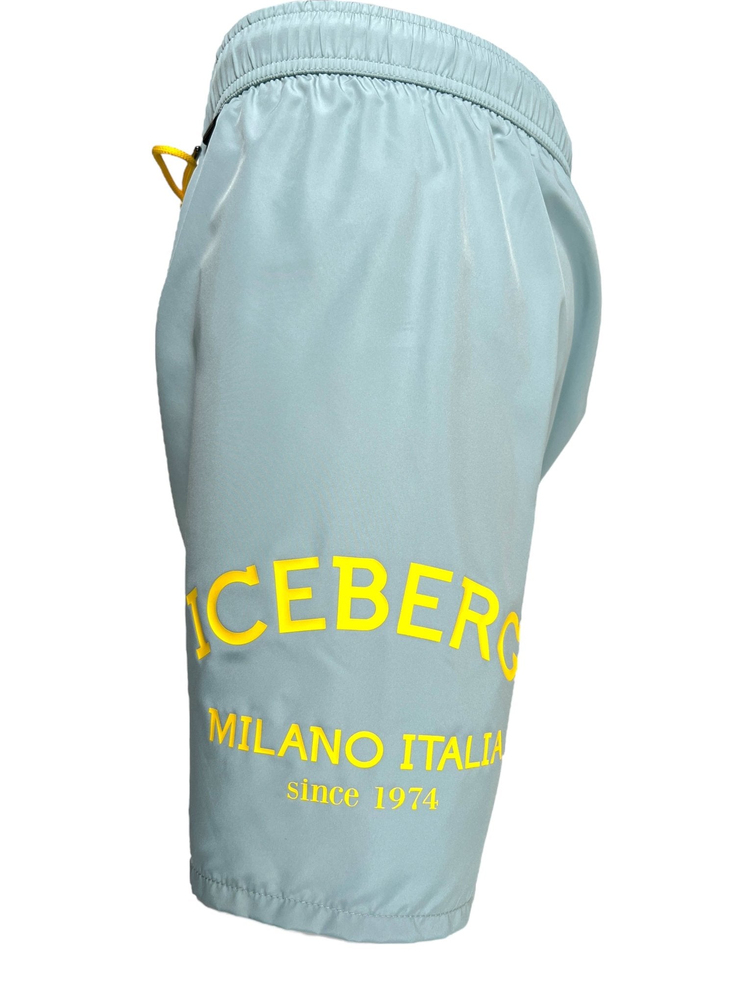 The Iceberg ICE25MBM01 Medium Boardshort in mint features yellow "ICEBERG MILANO ITALIA since 1974" side text, a side pocket, elastic waistband, and is made from 100% polyester. Imported. Brand: ICEBERG.