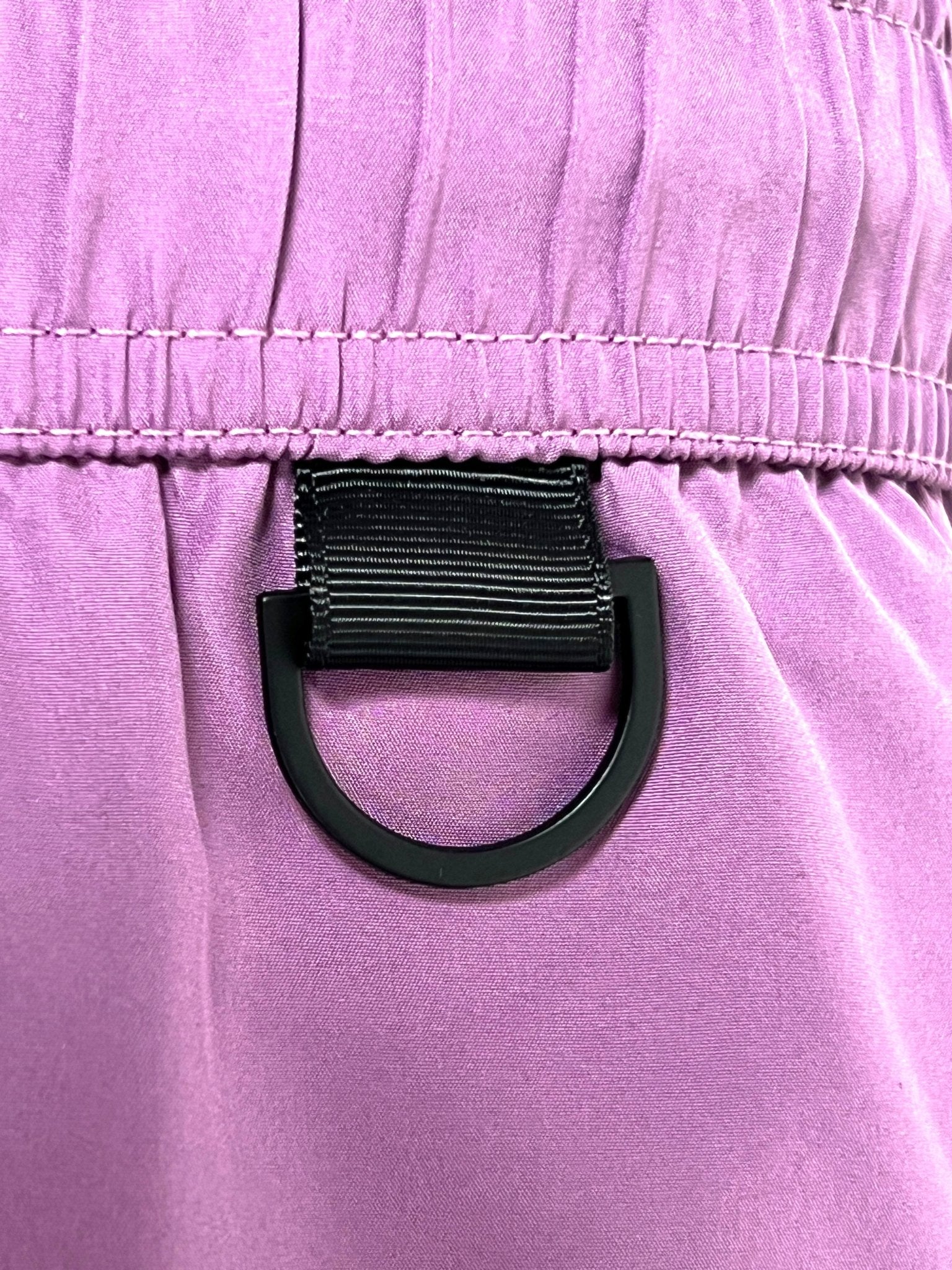 Close-up of a black D-ring on the waistband of ICEBERG’s ICE25MBM01 Medium Boardshort in Raspberry, inspired by the brand’s signature stylish trunk design.