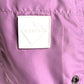 Close-up of a raspberry polyester ICEBERG ICE25MBM01 Medium Boardshort, featuring a white rectangular "ICEBERG" patch and a small round metal "ICEBERG" button.