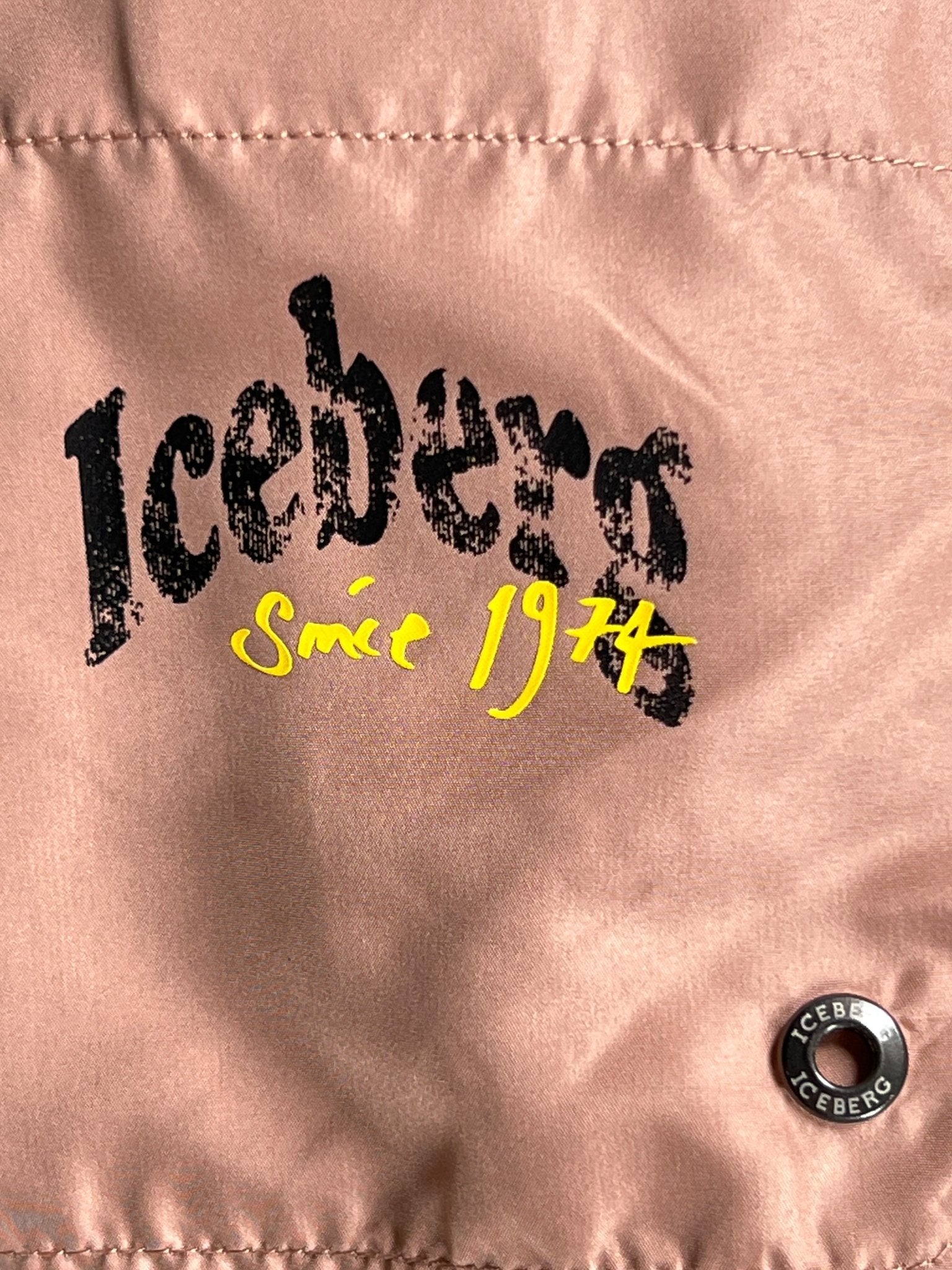 Close-up of ICEBERG ICE25MBS03 Short Boardshort in Blush, crafted from 100% polyester with "Iceberg since 1974" text and a metallic "Iceberg" button. Imported for style and comfort.