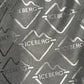 Close-up of the textured polyester fabric from the Iceberg ICE25MBS05 Short Boardshort Black, featuring a repeated "ICEBERG" logo and mountain outline in monochrome, by ICEBERG.