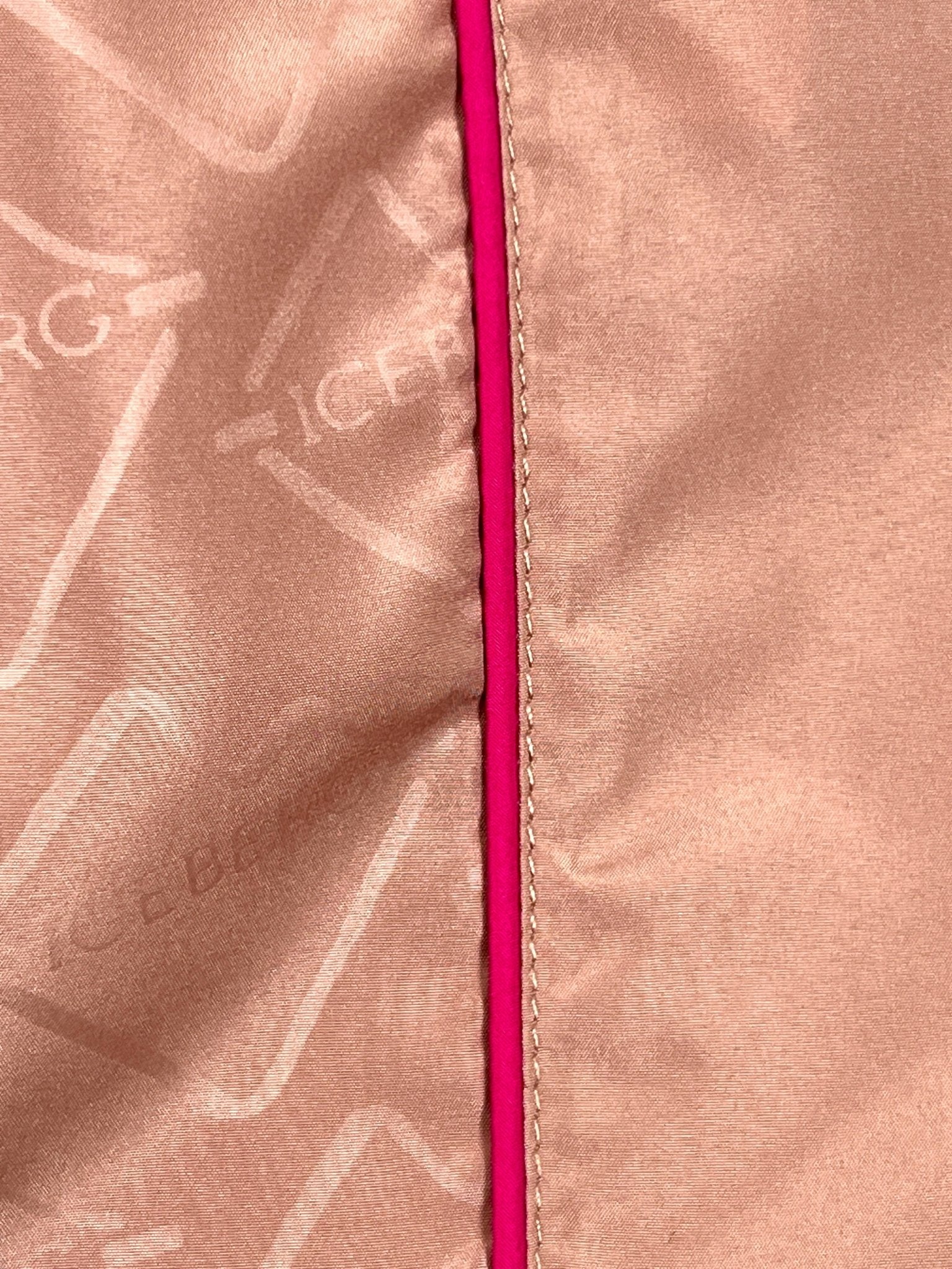 Close-up of blush pink polyester fabric from the ICEBERG ICE25MBS05 Short Boardshort, featuring a darker pink vertical seam and a subtle repeating "ICEBERG" logo pattern on the left side.