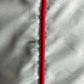 Close-up of mint fabric from the ICEBERG ICE25MBS05 Short Boardshort, showing a vertical stitched seam and bright red trim on the right side. Made from 100% polyester for comfort and durability.