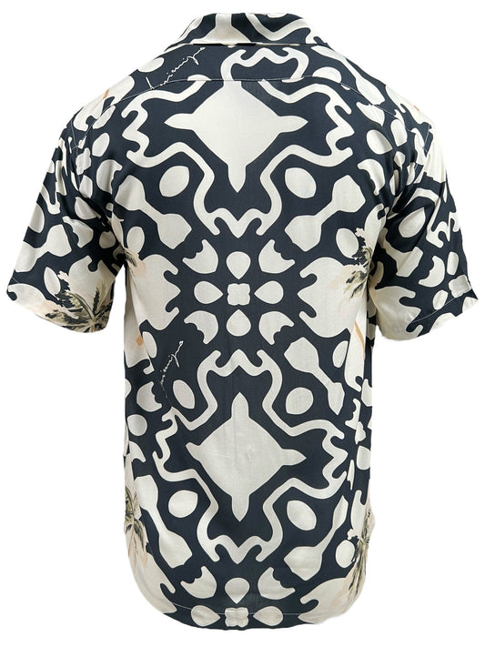Back view of the INIMIGO ISH3525 PALM SHIRT BLACK from the INIMIGO collection, showcasing a short-sleeved shirt with a black and white symmetrical abstract pattern. The design features subtle floral motifs on a light background, exuding a tropical vibe.