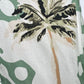 A versatile button-down fabric with a green and beige abstract pattern featuring a large palm tree print, the INIMIGO ISH3525 PALM SHIRT GREEN by INIMIGO.