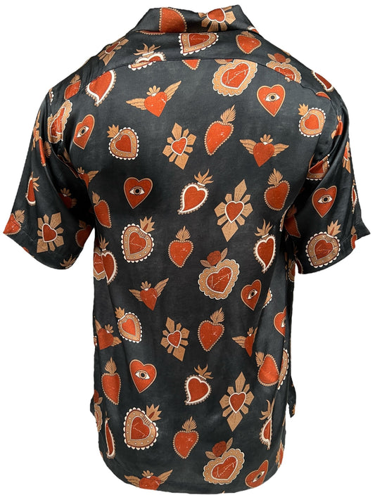 A versatile men's shirt, the INIMIGO ISH3527 MEXICAN HEARTS SHIRT BLACK features a black base adorned with a pattern of red hearts, eyes, and wing designs.