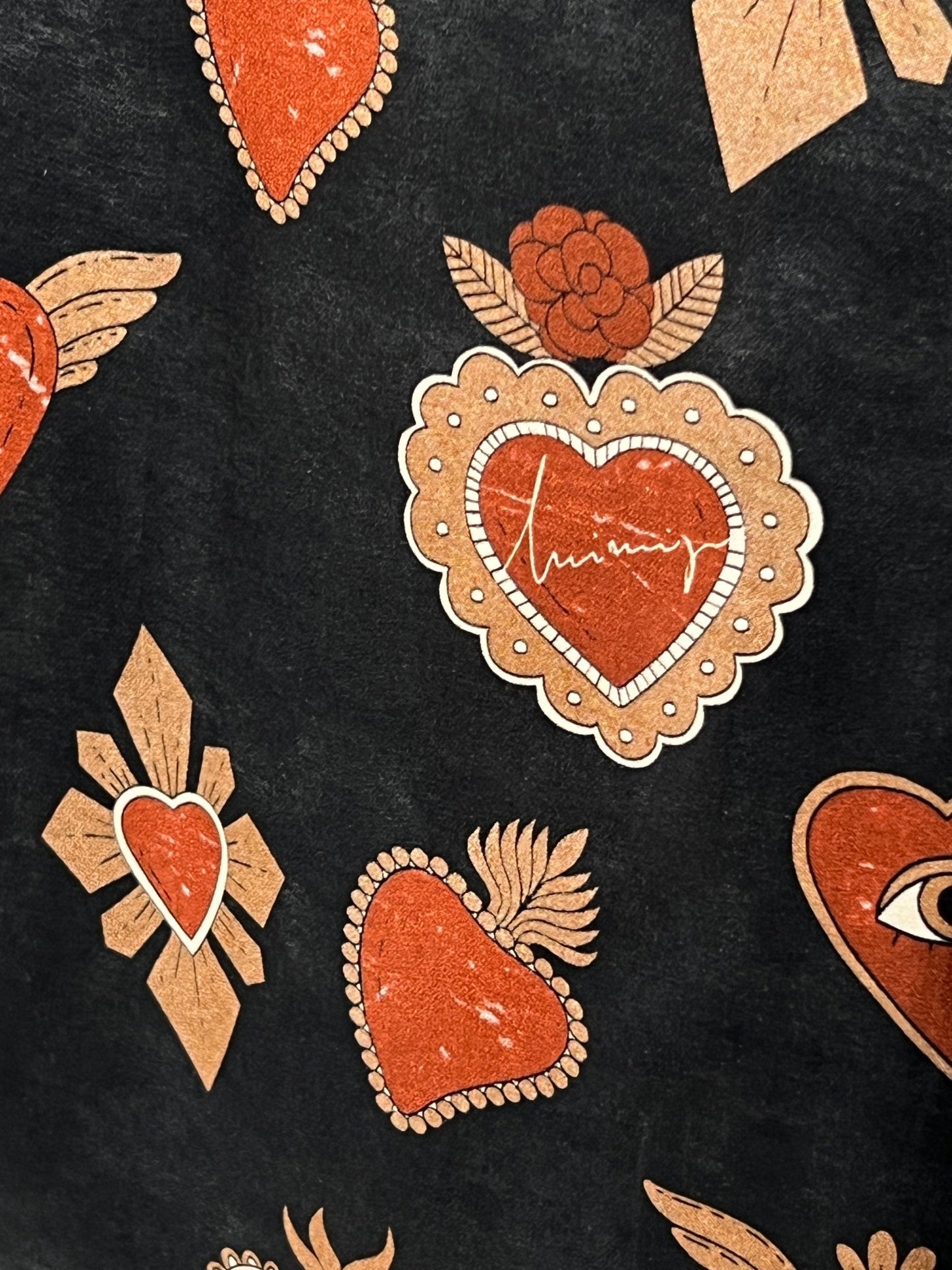 Pattern featuring hearts, eyes, roses, and leaves, with one heart containing the word "amour" in cursive, set against a black background. The elements are in red and beige colors—perfect for a versatile men’s shirt or the INIMIGO ISH3527 MEXICAN HEARTS SHIRT BLACK by INIMIGO with an elegant twist.