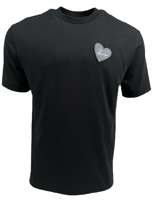 INIMIGO ITS3508 HEART PATCH T-SHIRT BLACK by INIMIGO made from 100% cotton, featuring a small leather heart detail with the word "Amour" on the upper left chest area.