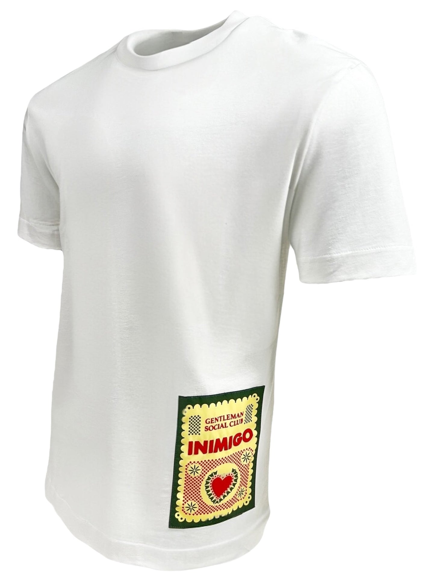 The Inimigo ITS3539 Mexican T-Shirt White by INIMIGO is a white cotton garment featuring a colorful rectangular patch on the lower side, displaying text and a heart design.