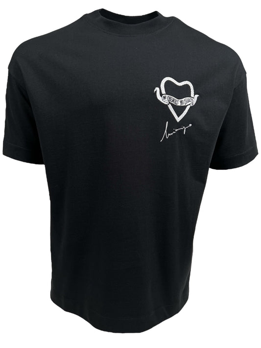 A black, 100% cotton INIMIGO ITS3573 HEART STROKE TEE BLACK featuring a small embroidered heart design on the upper left chest, with cursive text and an INIMIGO signature beneath it.