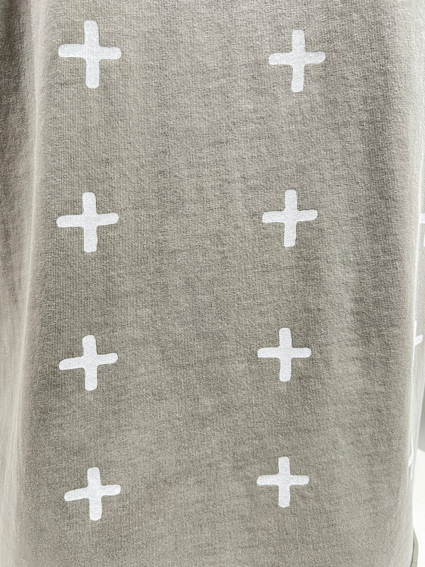 Gray fabric with a pattern of white crosses evenly spaced across the surface, perfect for an oversized tee made from premium cotton jersey, such as the KSUBI ALL DAY BIGGIE TEE OUTBACK GRN by KSUBI.