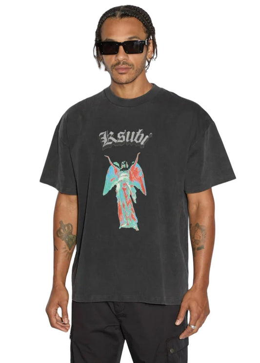 A person wearing sunglasses, dark pants, and the KSUBI ANGELIK EKCESS SS TEE in acid black—a heavyweight cotton jersey t-shirt featuring a graphic angel design and the brand name "Ksubi.