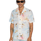 An individual is modeling a Ksubi Dreamers Resorts Shirt Multi, complemented by light jeans and chic sunglasses against a plain background.