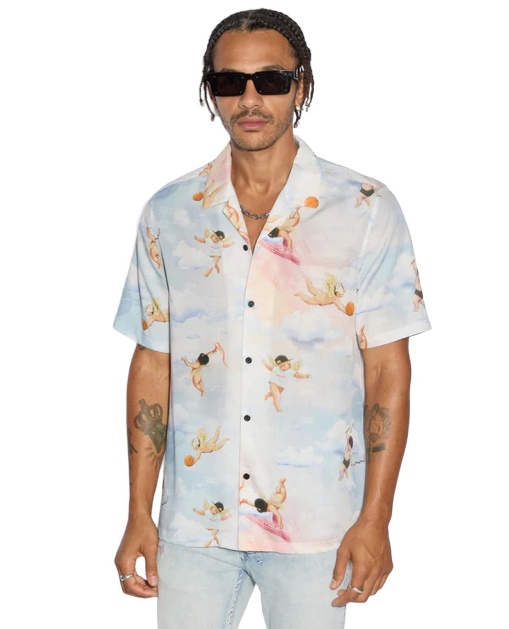 An individual is modeling a Ksubi Dreamers Resorts Shirt Multi, complemented by light jeans and chic sunglasses against a plain background.