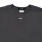 The Ksubi Eagle Biggie SS Tee in faded black is 100% cotton, featuring a small white "ksubi" logo on the chest and a black tag with white text at the neckline.