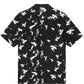 KSUBI FLIGHT RESORT SS SHIRT BLACK, a short-sleeve button-up featuring a white dove print pattern and Ksubi branding, crafted from soft Tencel fabric.