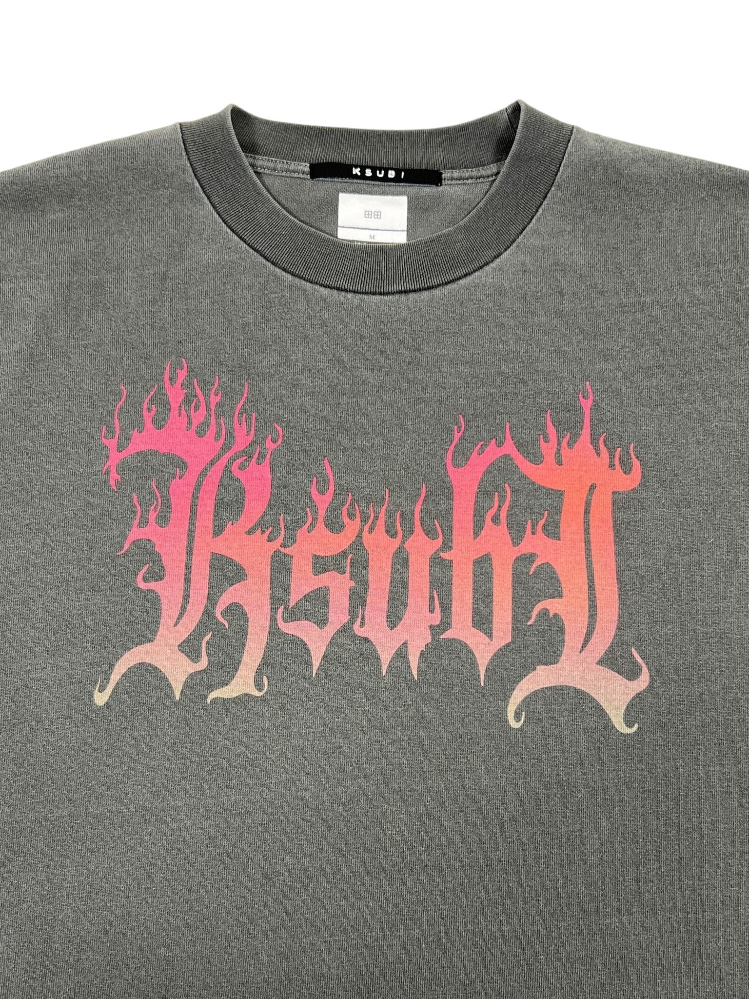 The Ksubi Fuego Ekcess SS Tee in faded black features a chic pink flaming "Ksubi" text graphic.