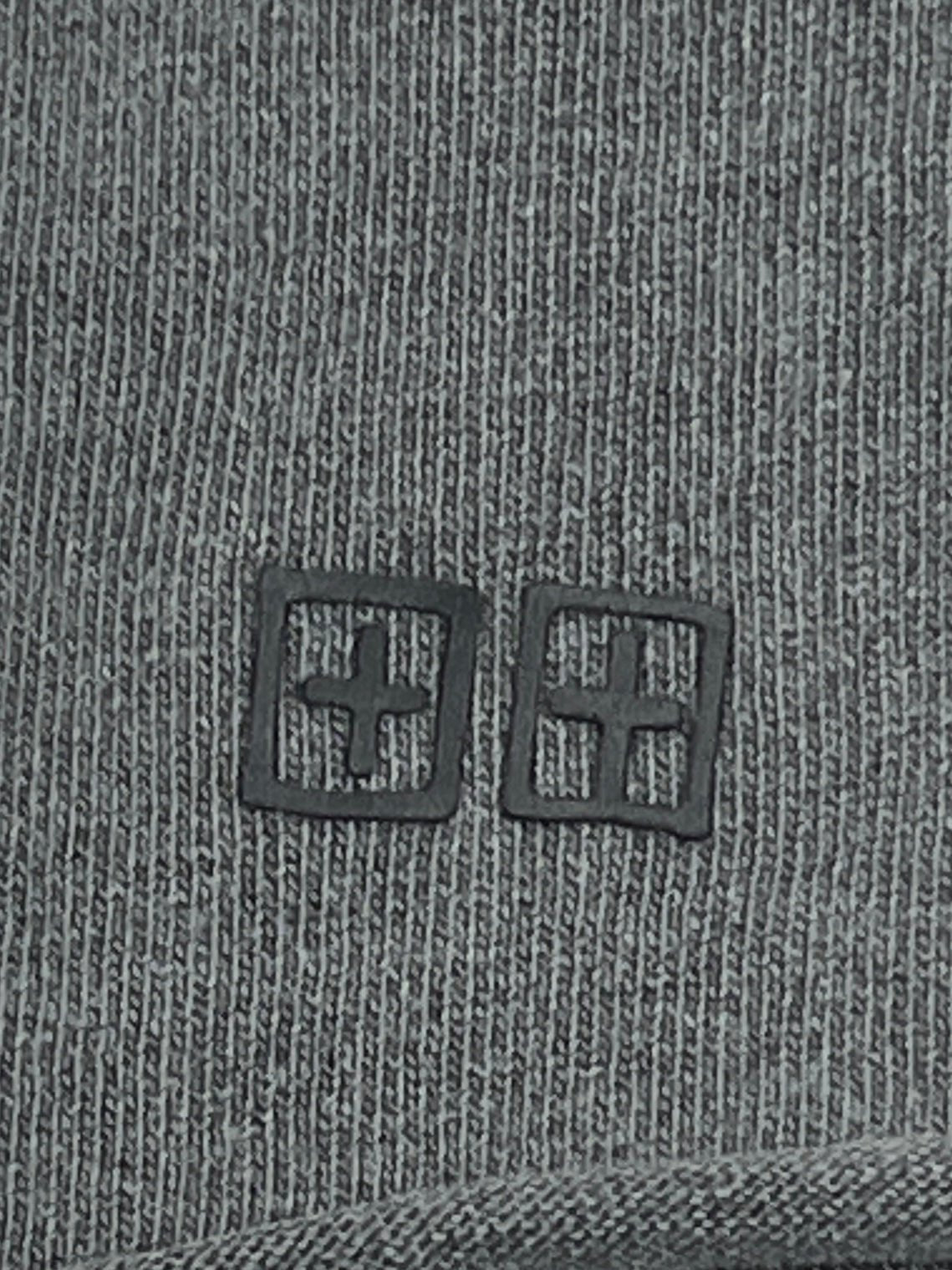 Close-up of the gray knit fabric from the KSUBI Fuego Ekcess SS Tee in Faded Black, showcasing two vintage black square symbols with plus signs.
