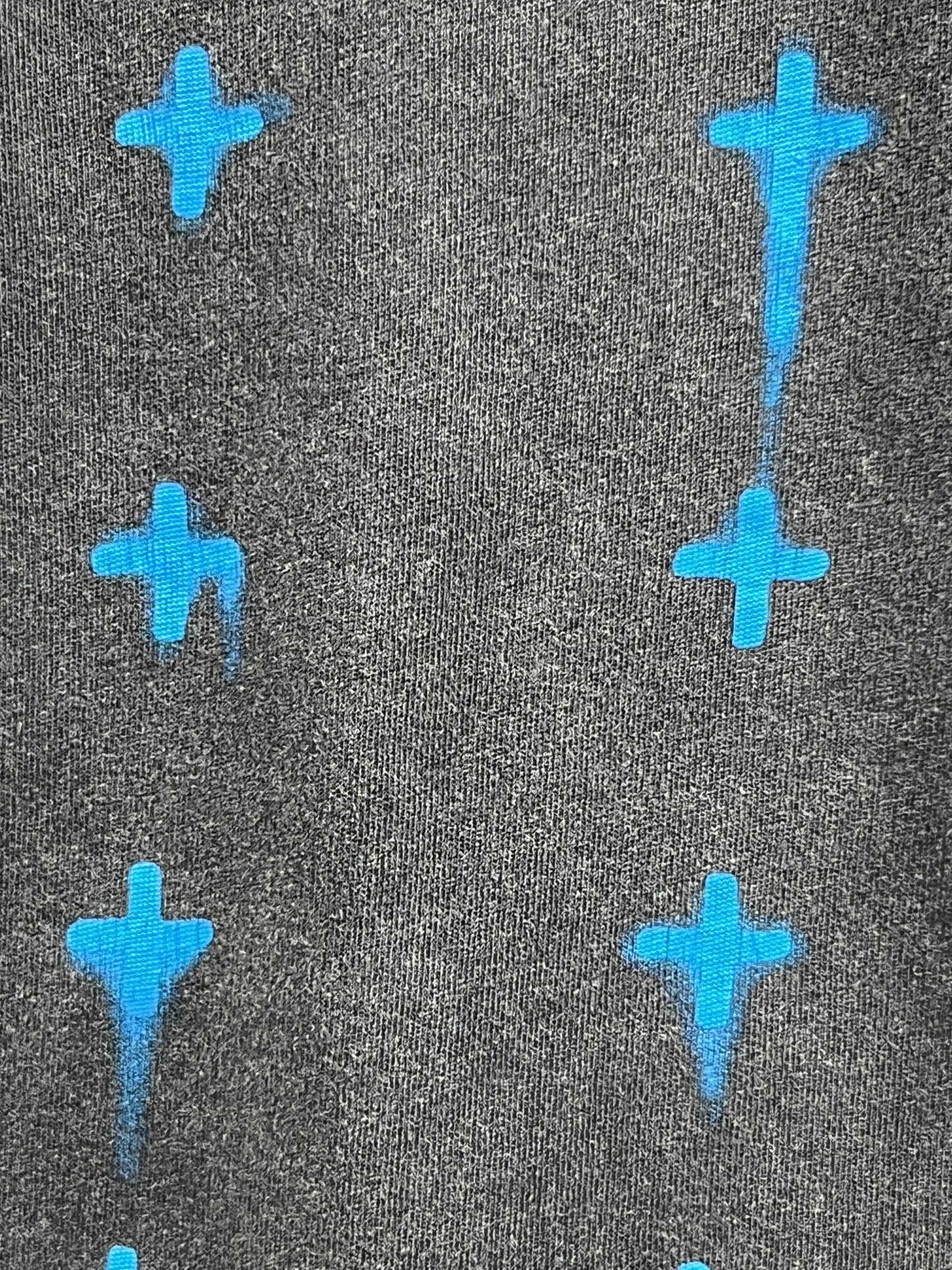 Ksubi Graff Rose Kash Tee Acid Grey by KSUBI features a repeating pattern of blue airplane shapes.