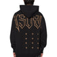 Someone wears the Ksubi Kingdom Biggie Hoodie in jet black by KSUBI, with bold "KSUBI" lettering and plus sign pattern on the back, standing against a white background.