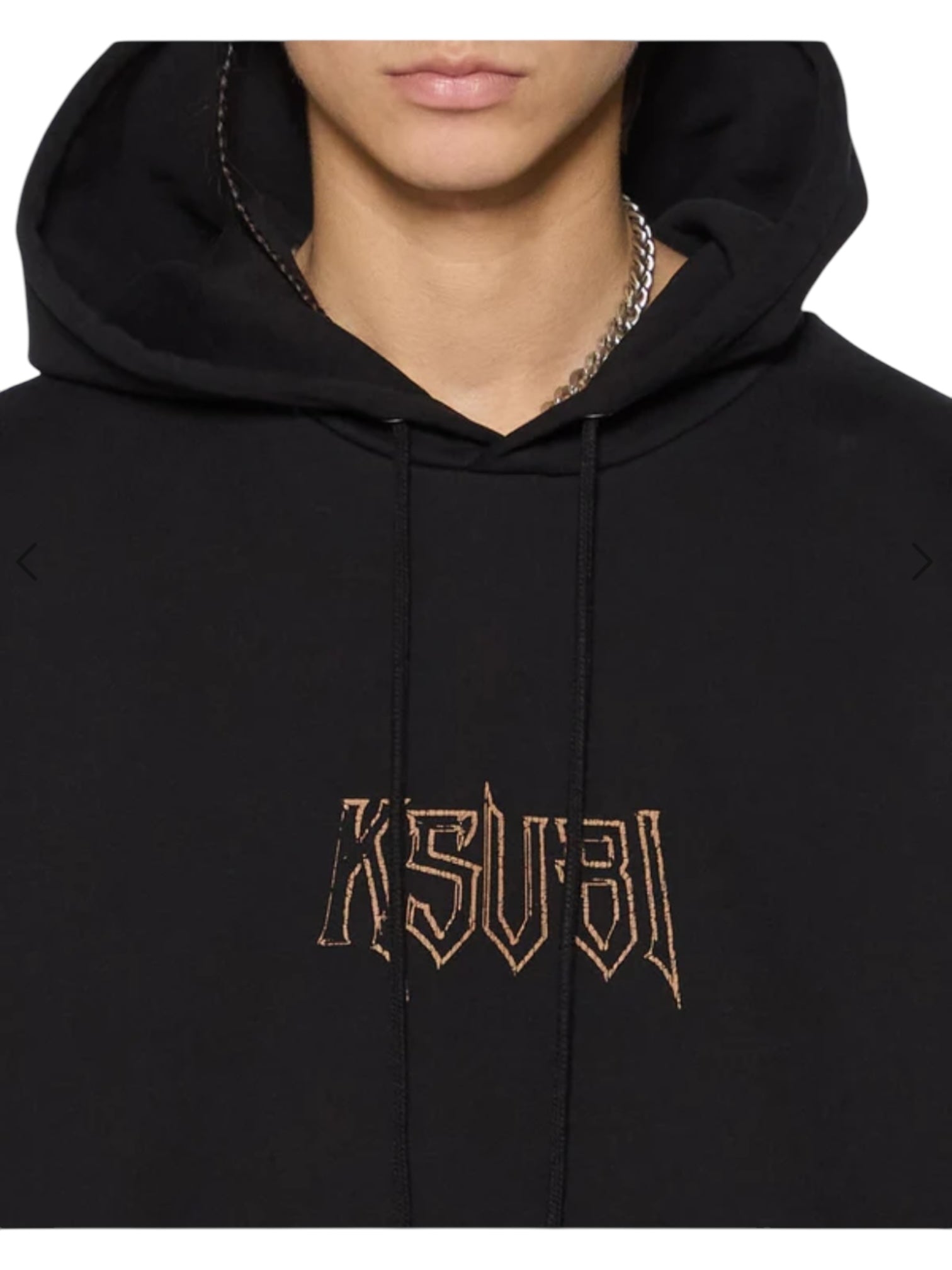 Someone wearing the Ksubi Kingdom Biggie Hoodie in jet black by KSUBI, featuring oversized fit and "KSUBI" embroidered in stylized letters on the front.