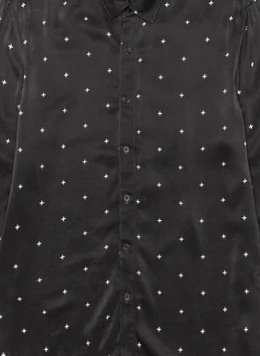 The KSUBI Polka Plus Ls Shirt Black is a stylish polyester button-up with long sleeves, featuring small white cross patterns for a sleek look.