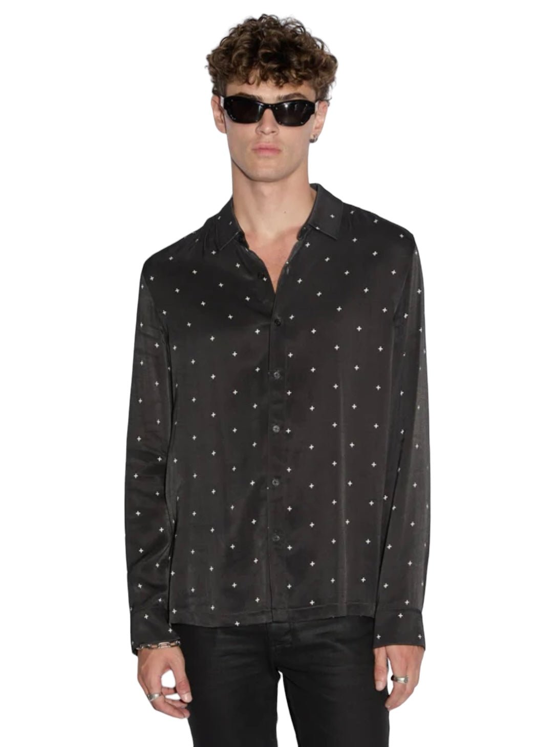 A person wearing sunglasses, a stylish Ksubi Polka Plus Ls Shirt Black—a KSUBI long sleeve button-down—and black pants stands against a plain background.