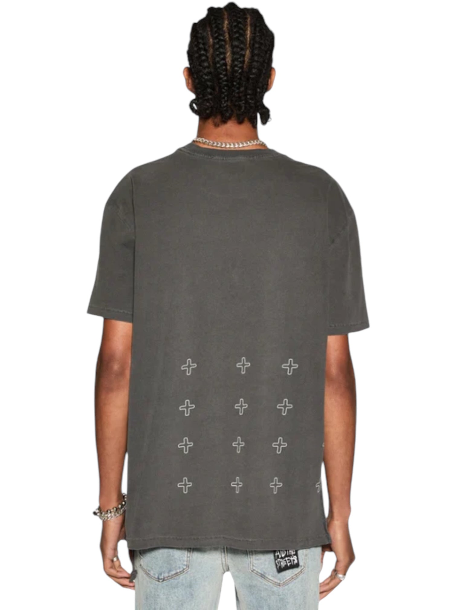A person with braided hair is seen from the back, wearing a Ksubi Skull Biggie Ss Tee in Faded Black by KSUBI, featuring cross patterns, paired with premium cotton light jeans.