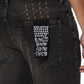Close-up of the back pocket on KSUBI Van Winkle Kingdom Repair Black skinny jeans, showing a patch with "Royalty Heroism And The Streets" and a pattern of white Ksubi cross logos above the pocket.