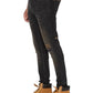 A person in KSUBI Van Winkle Kingdom Repair Black skinny jeans with a knee patch and tan lace-up work boots with the Ksubi logo stands against a white background.