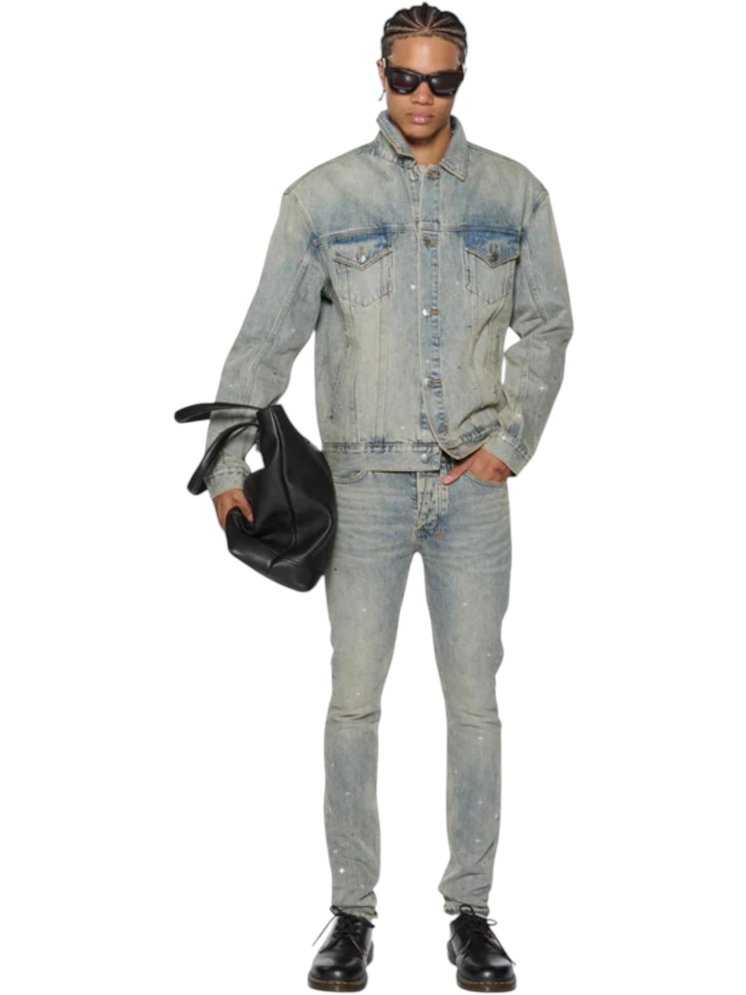 A person wearing KSUBI Van Winkle Stagelight Metalik denim jeans, a light blue premium jacket, skinny jeans, black shoes, sunglasses, and carrying a black bag. Ksubi branded hardware adds a stylish touch.
