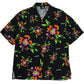 A vibrant short-sleeved MAUNA-KEA MKU142-FL FLORAL SHIRT BLK with a bold graphic roses print in orange, green, and purple, made in Italy and displayed on a flat surface.