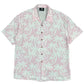The Mauna-Kea Mku142-Pm3 Allover Print Shirt Pink by MAUNA-KEA offers a short-sleeve design with a light pink background adorned with white palm leaf patterns. It's an ideal choice for anyone looking to combine style and comfort in a single fashionable piece, reminiscent of the breezy Mauna Kea landscapes.