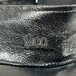 A close-up of the Mcq By Mcqueen 692287Rgc96 Handsy Visor Black cap, showcasing its black leather with a shiny texture and embossed "MCO" letters.