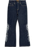 The BIRTH OF ROYAL CHILD Only The Blind BC25SSPT22 Raw Pearl Flared Jeans Blue feature dark blue raw denim, white embroidery, and silver studs on the lower outer sides of each leg.