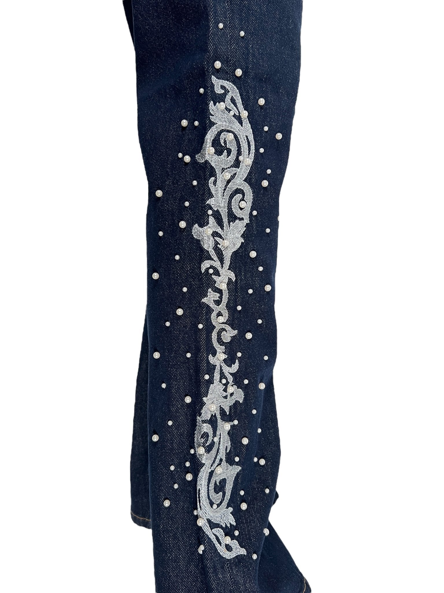 Close-up of BIRTH OF ROYAL CHILD Only The Blind BC25SSPT22 Raw Pearl Flared Jeans in Blue, featuring vertical ornate white embroidery and scattered pearl-like embellishments.
