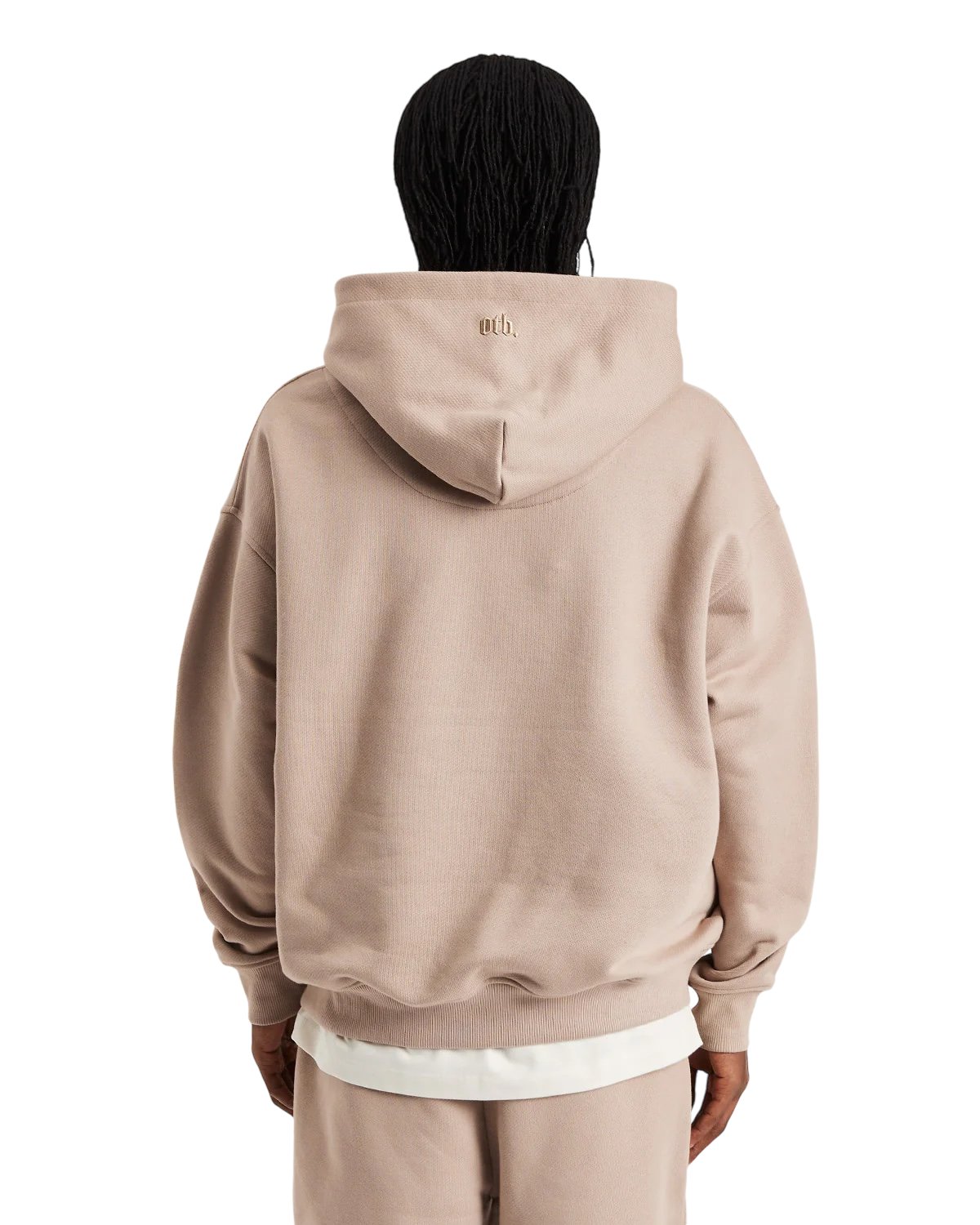 A person wearing an oversized heavyweight cotton hoodie and pants from ONLY THE BLIND, facing away. The Only The Blind OTB-H1033 Ogiku Embroidered Hood features a subtle blossom design on the back, effortlessly combining style and comfort.