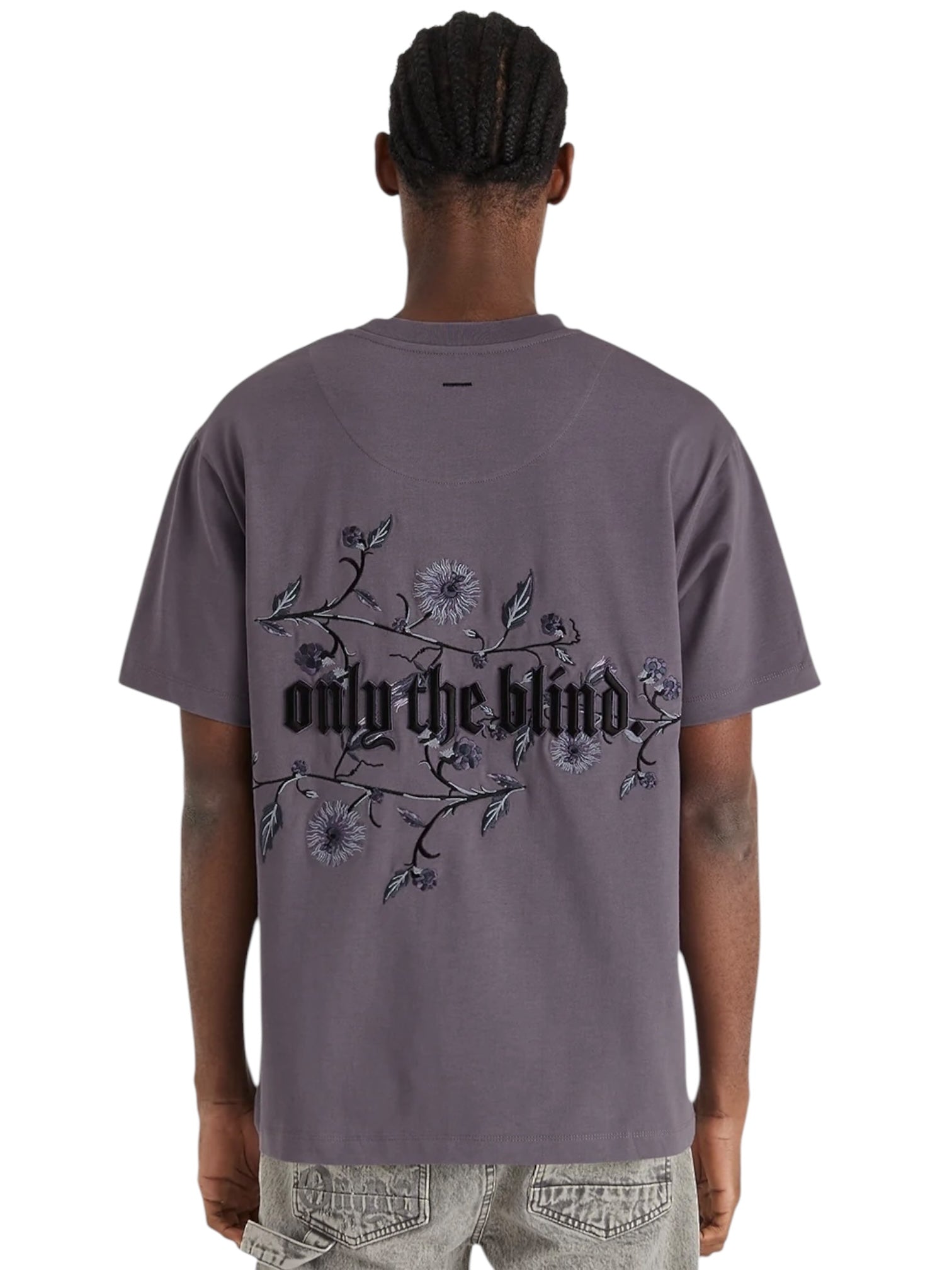 Dressed in the ONLY THE BLIND OTB-T1383 Wildflower T-shirt in purple with floral embroidery and light jeans.