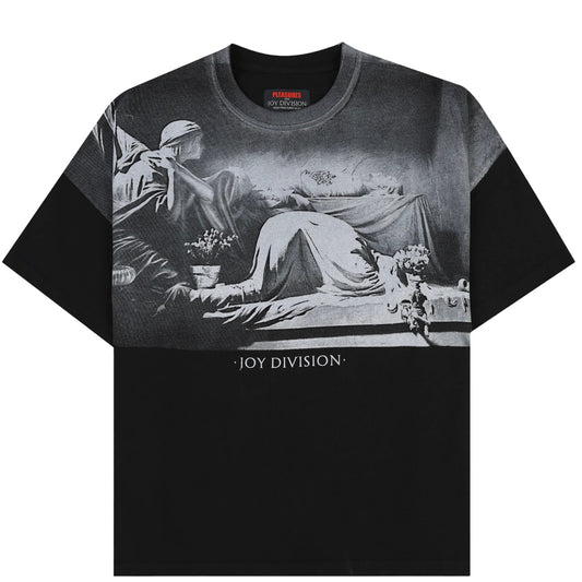 Black cotton jersey PLEASURES ATROCITY TEE BLK with a monochrome oversized plastisol print depicting a vintage scene and the text "joy division" below, part of an official collaboration with Joy Division.