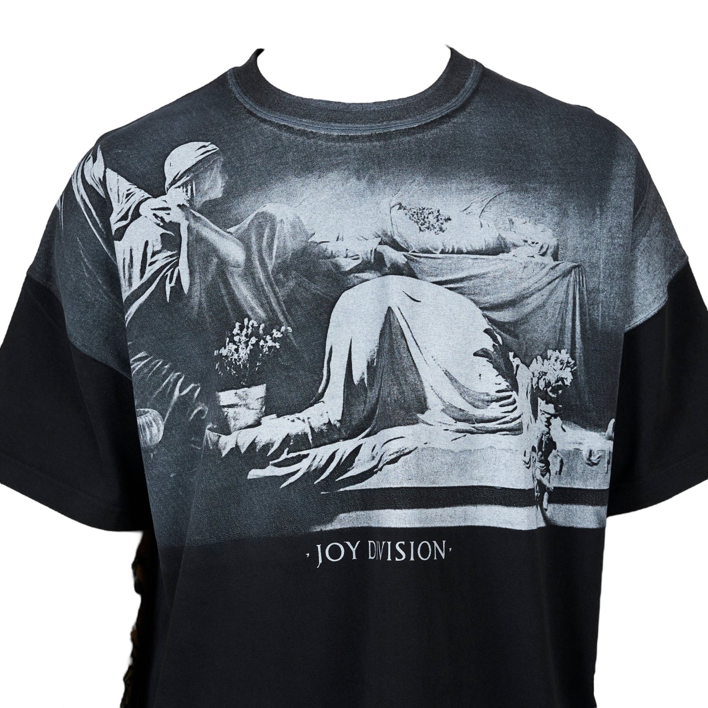Black oversized cotton jersey PLEASURES ATROCITY TEE BLK with a white plastisol graphic print featuring a draped figure and the text "joy division" below, an official collaboration with Joy Division.