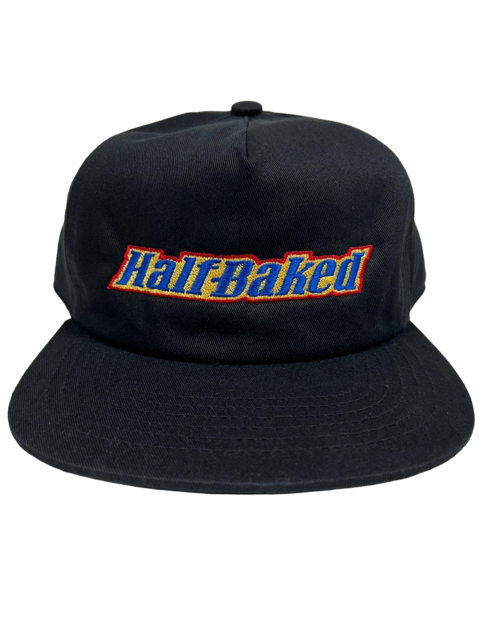 PLEASURES BAKED LOGO SNAPBACK BLACK hat made from polyester and nylon featuring "Half Baked" embroidered on the front in blue, yellow, and red letters.
