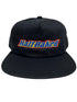 PLEASURES BAKED LOGO SNAPBACK BLACK hat made from polyester and nylon featuring "Half Baked" embroidered on the front in blue, yellow, and red letters.