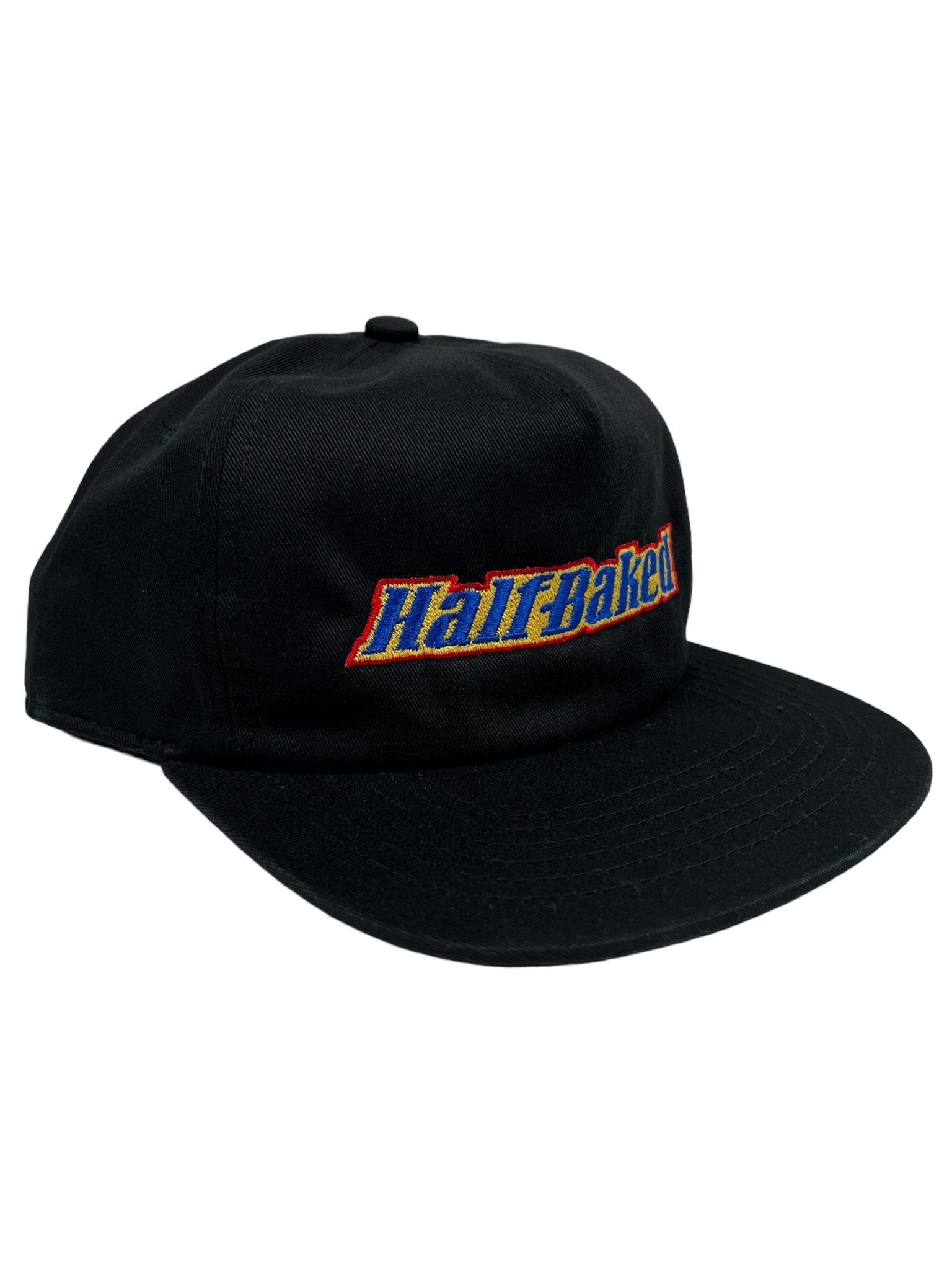 PLEASURES BAKED LOGO SNAPBACK BLACK hat, featuring "Half Baked" embroidered in colorful letters on the front, made from a durable blend of Polyester & Nylon.