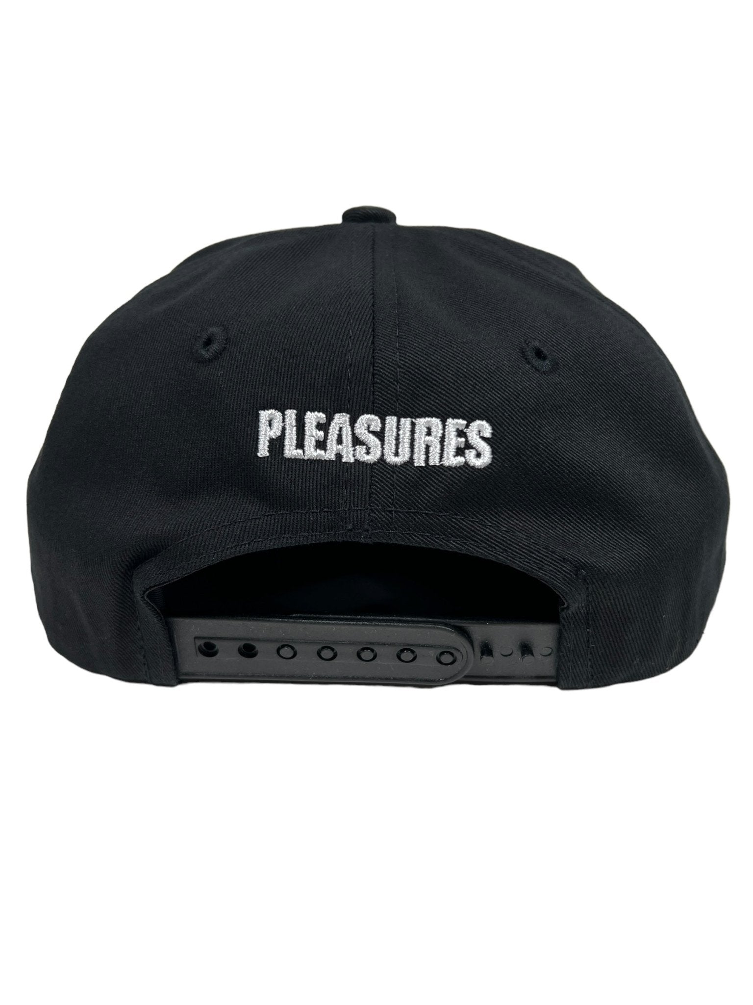 The PLEASURES BAKED LOGO SNAPBACK BLACK is displayed from the back, showcasing the word "PLEASURES" embroidered in white thread. This cap, crafted from durable Polyester and Nylon, includes an adjustable plastic strap for a perfect fit.