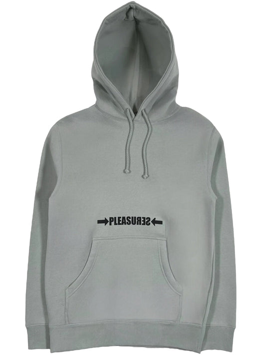 The Pleasures Crash Hoodie in sage features a cozy cotton-polyester blend, includes a front pocket and drawstrings, and showcases "PLEASURES" screen printed in black text with outward-pointing arrows.